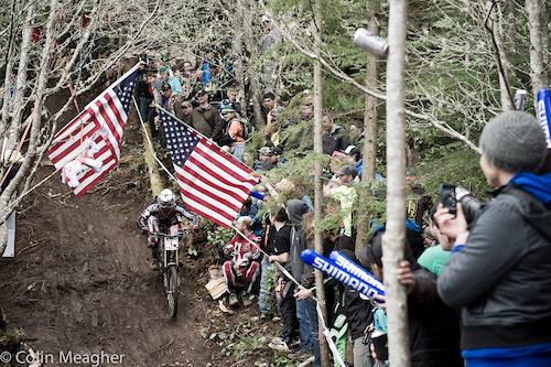 Title Sponsor Diamondback's Kyle Thomas parting the red, white, and blue curtains in the waterfall line.