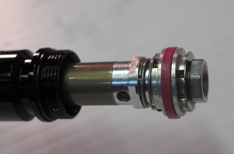 Rebound damping can be controlled via an orifice, a shim stack, or a combination of both.