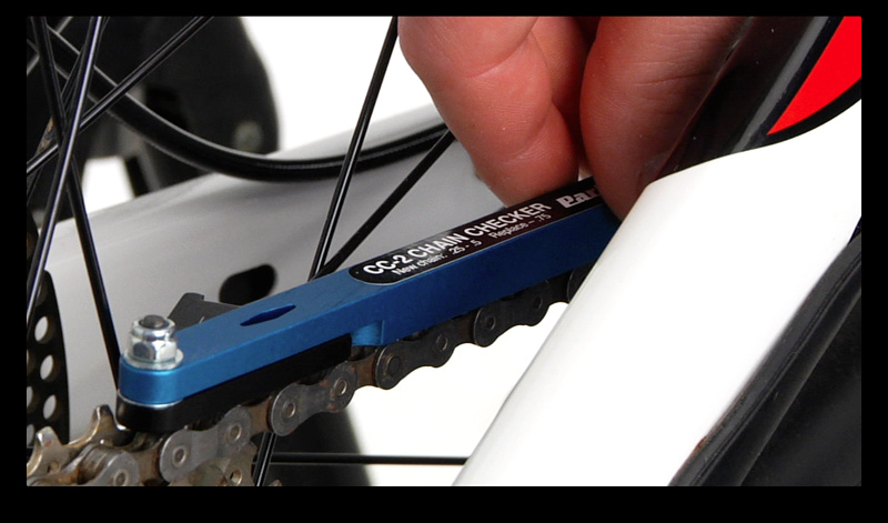 Step 1. Turn the gauge on the CC-2 tool to zero and place both pins into the gap between the rollers