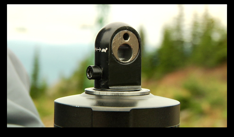 This eccentric insert, shown in a Vivid Air removed from a different 2011 Demo 8, takes the place of the standard Fox shock bushing and allows BB height and head angle adjustment.