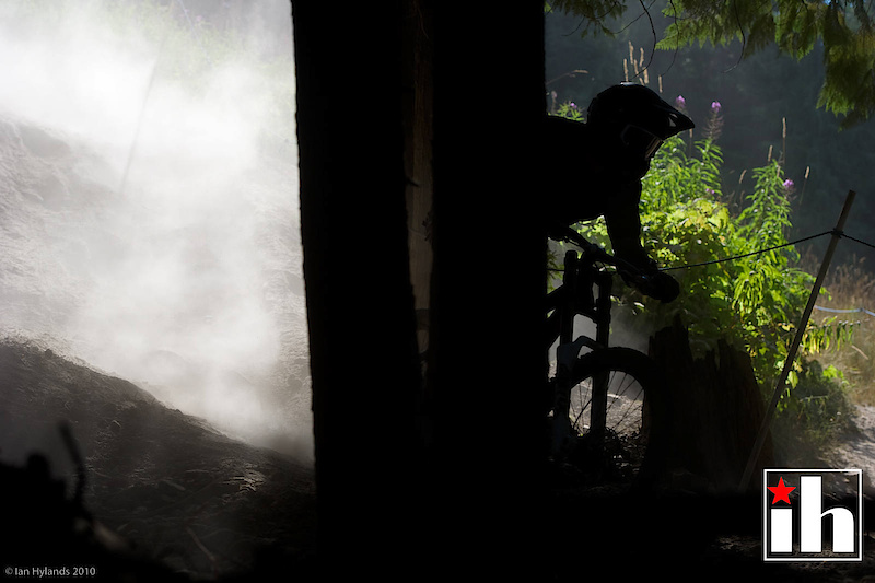 This image has a lot going on as far as light. The backlit dust is really bright, almost too blown out in spots, but the rider in the trees is a complete silhouette. Solid clipped shadow,almost no detail at all except for some bits reflected off his helmet and goggles...