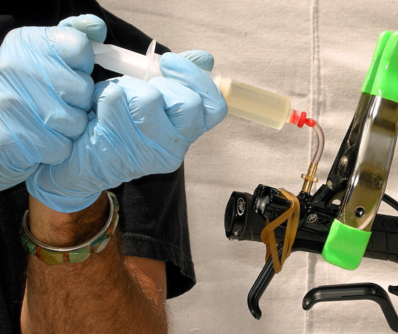 Close the RX brake lever with a rubber band and pull a vacuum to free remaining air.