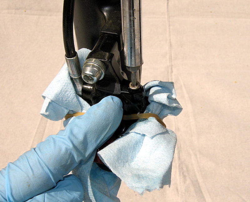 Unscrew the syringe and replace the RX bleed port plug.