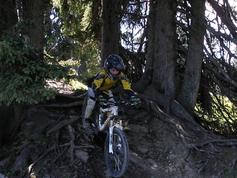 Rookie Freeride Camp Mastering difficult roots in the wooden section of the Hangman I trail.