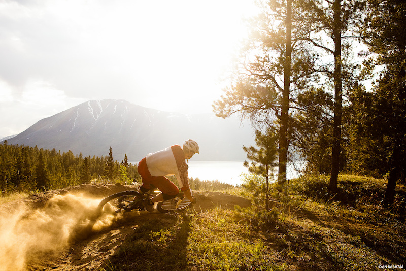 Sam Reimer kicks up a cloud of dust while cornering his mountain bike in Carcross Yukon Canada