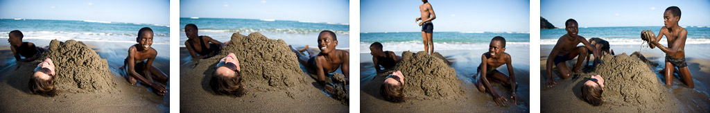 Katie Holden relaxes with some children at the black sand beach near Robins Bay in Jamaica at the Jamaica Fat Tyre Festival.