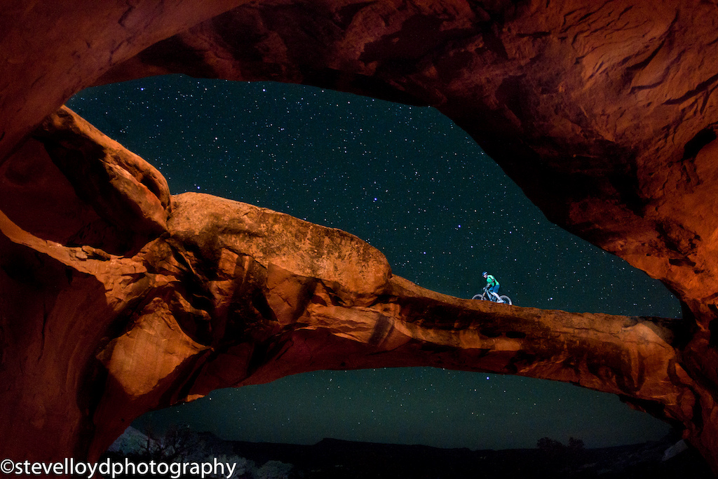 Carston riding an arch near Moab Utah