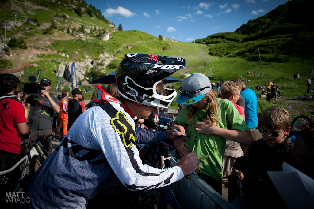 Signing autographs for the fans.