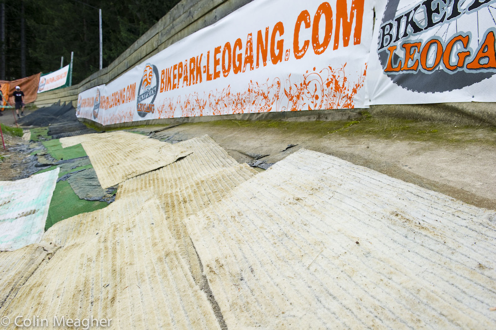 The berms in the opening section of the track have been groomed out for the World Champs but that dirt s moist and has a lot of clay to it. If--no when--it rains here tthe bomb holes that are going to develop in those berms are going to resemble a WWII gunnery range. And then it s onto the sketchy rubber mats lining a right hander and straight away onto the--depending on whom you talk to-- surprisingly grippy white astroturf seen above or the white astroturf of death also seen above.